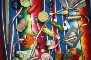 Home flat lay photography of vial, medal, and book on striped cloth